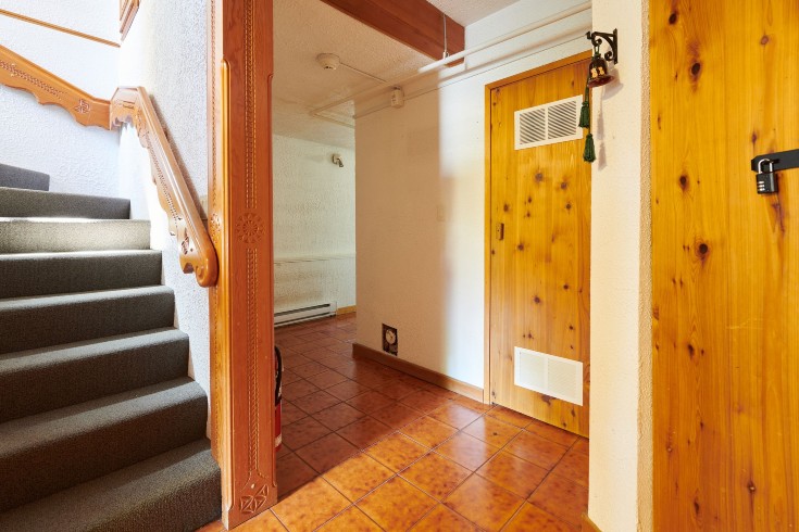 Dated stairway with orange wood paneling