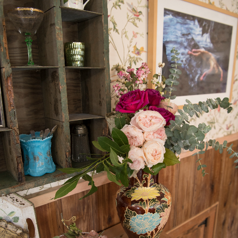 Close up of the roses and artwork in the front room at The Roadhouse