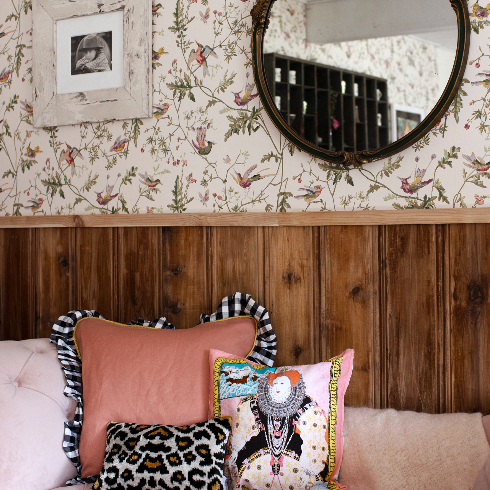 A shot of the pink velvet chaise with quirky pillows in the front room at The Roadhouse