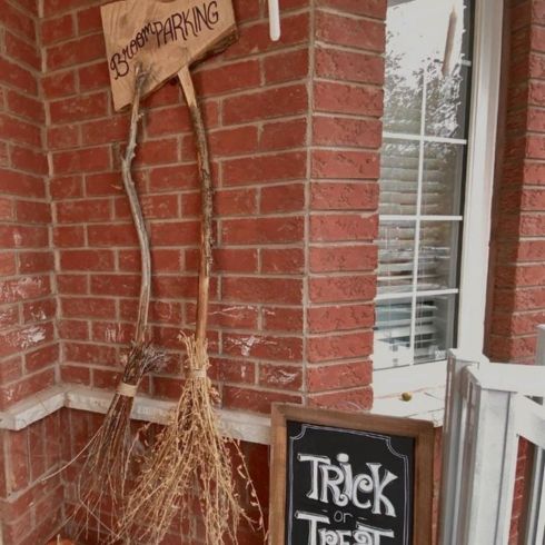 DIY halloween decor idea featuring brooms