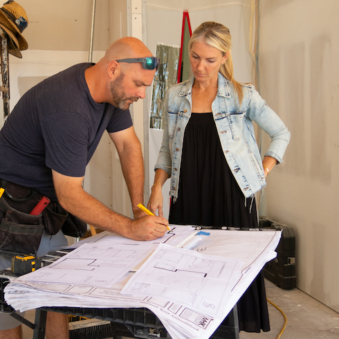 Bryan and Sarah Baeumler looking at floor plans