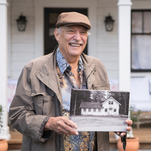 Barry stands out front The Roadhouse holding an old photograph of it