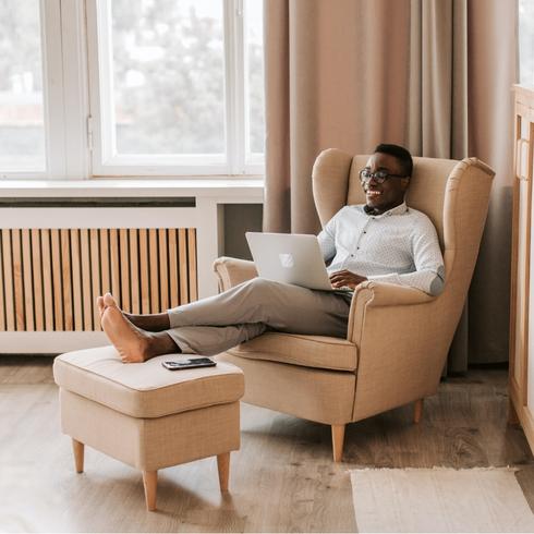 A man relaxing in a chair reading a book