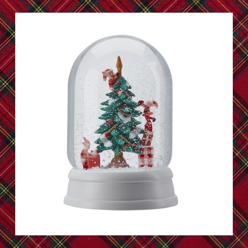 Snow globe of pigs decorating christmas tree