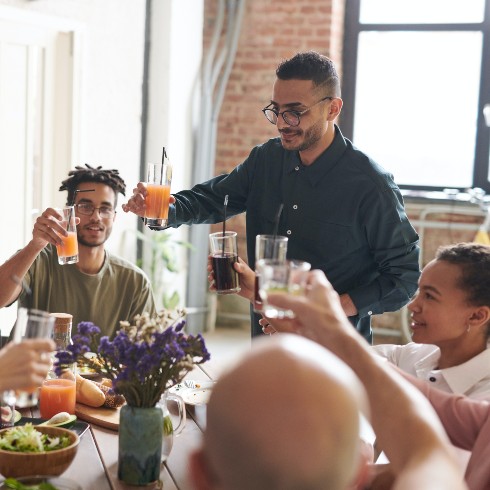 Friends toasting at the dinner table.