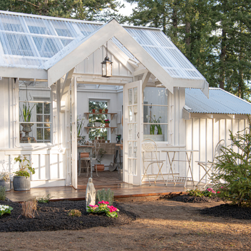 The exterior of The Potting Shed, showing clusters of flowers