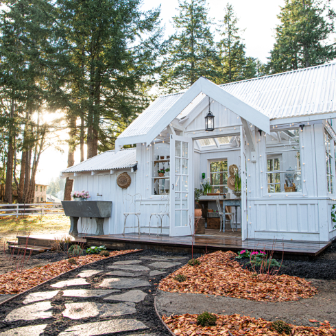 A wide exterior shot of the new potting shed, with stone pathway