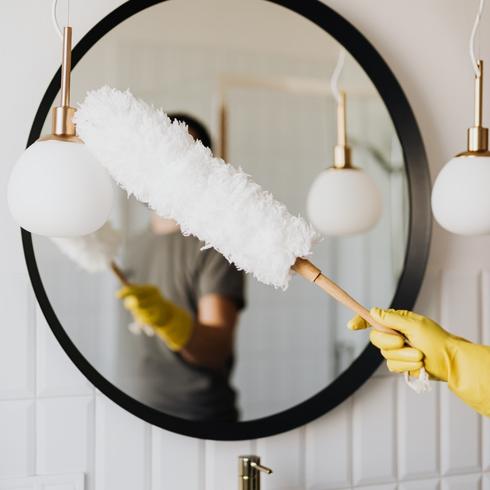 Woman dusting bathroom