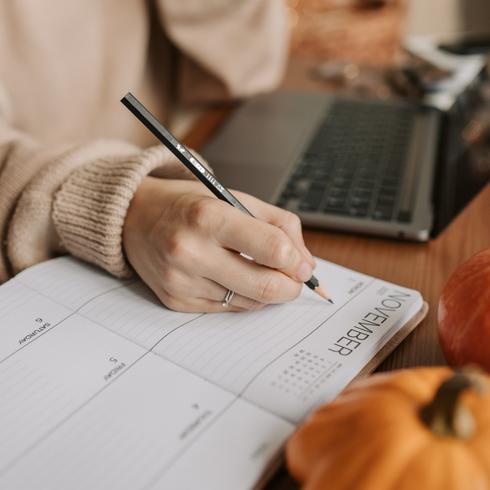 Person writing down cleaning schedule with 10 minute cleaning routines