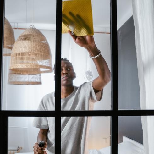 Man cleaning mirrors