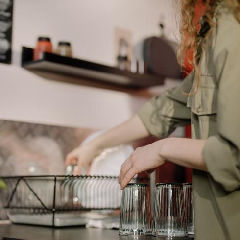 Woman putting dishes away