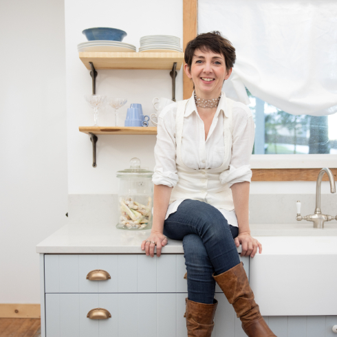 Francesca sits on the countertop in The Cabin kitchen