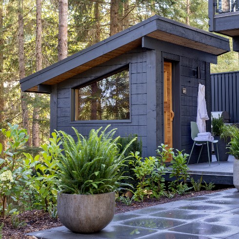 Black sauna with greenery