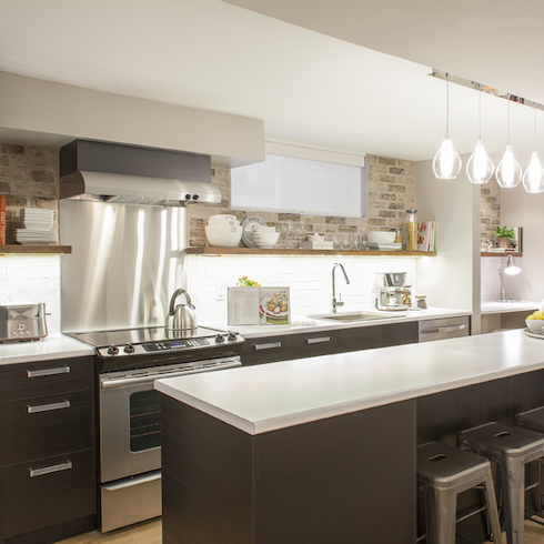 Home Network host Scott McGillivray mimics the look of exposed brick using in a basement kitchen with a gypsum material, then pipe in the grouting for an authentic feel, and painting the bottom half white for extra panache