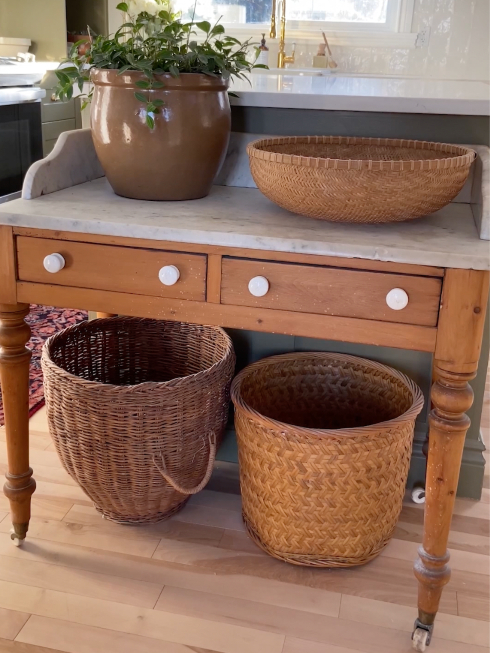 A small antiquw wooden table with a marble top