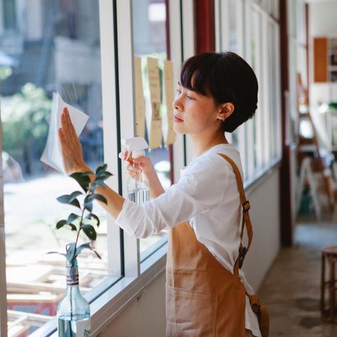 Woman cleaning glass window