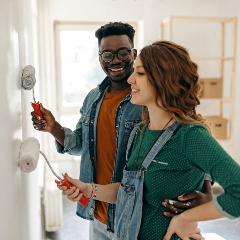 A couple painting their home white