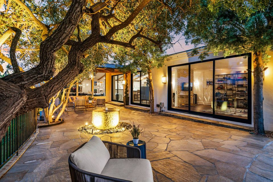 Flagstone patio and seating outside of a midcentury home