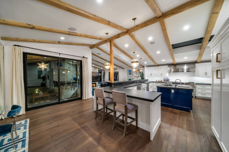 A large chef's kitchen with island, chairs and state-of-the-art appliances