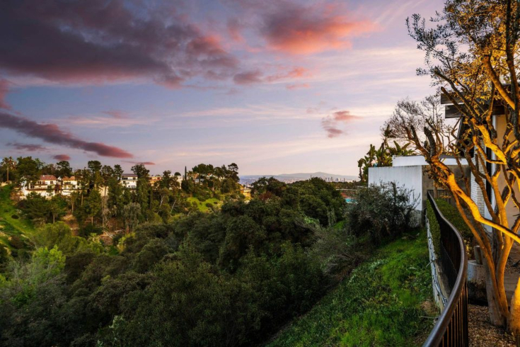 The view from the Hollywood hills of mountains, the city skyline and the canyon