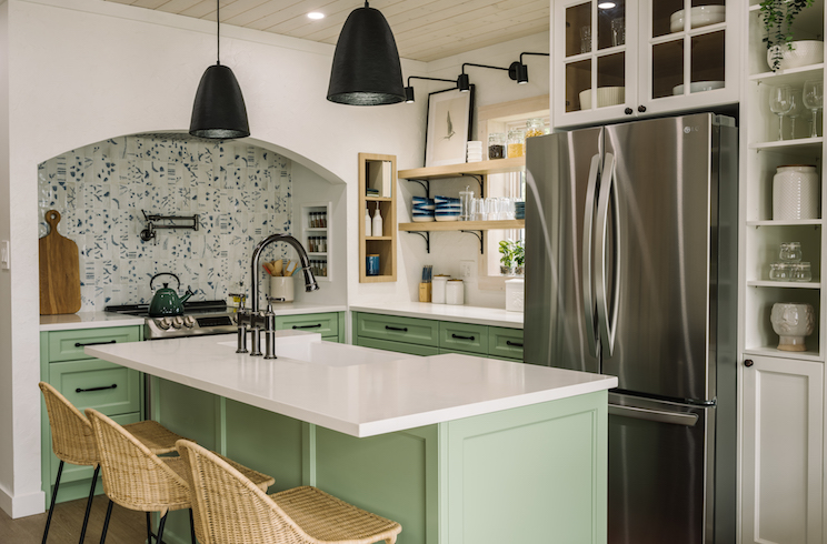 Arch in kitchen with mint green finishes on Renovation Resort