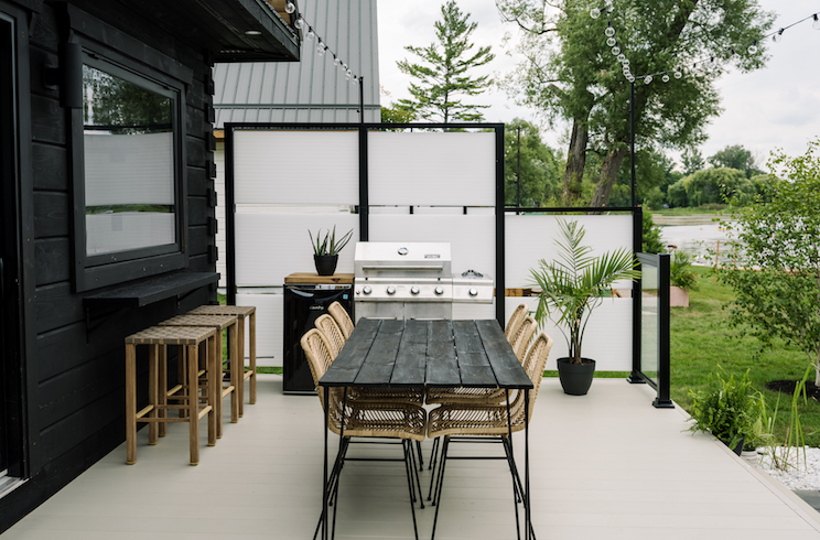 Black cabin exterior and deck with seating