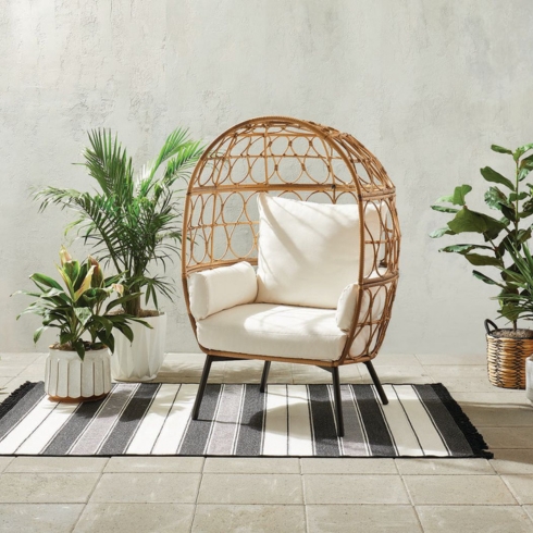 Rattan egg chair with white cushion