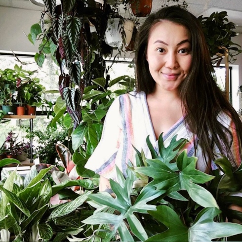 House of Plants owner Judie Tu surrounded by some of her plant creations