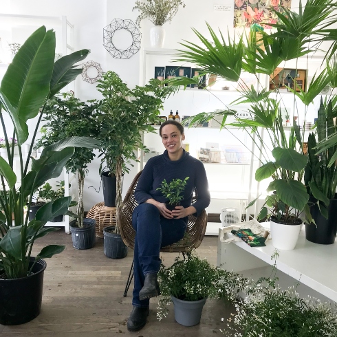 Miss Boon's Sarah Nagué sitting amongst some of her plant creations