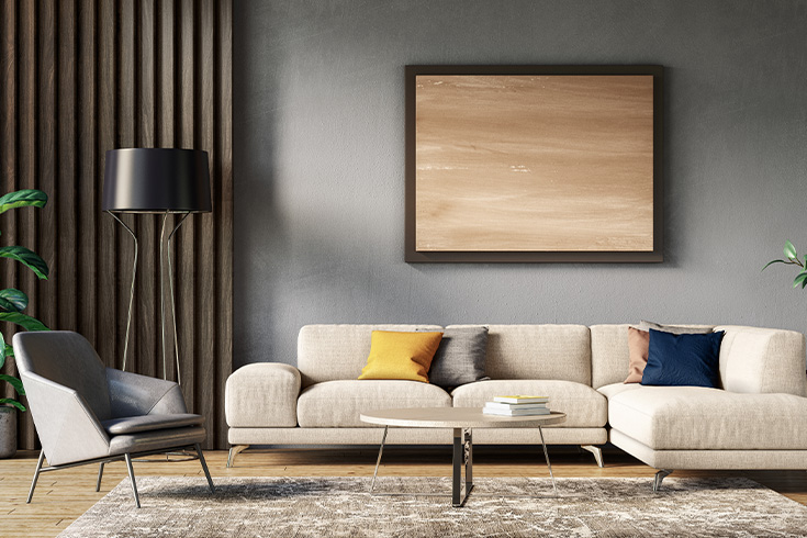 Living room with beige couch and dark gray wall