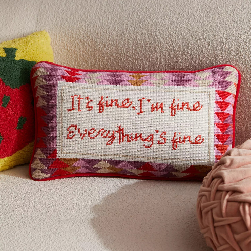 A crocheted pillow with a sassy slogan