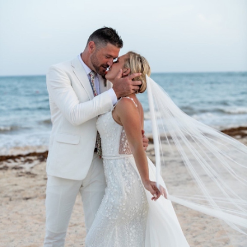 Kortney Wilson and Ryan Vella kissing at wedding