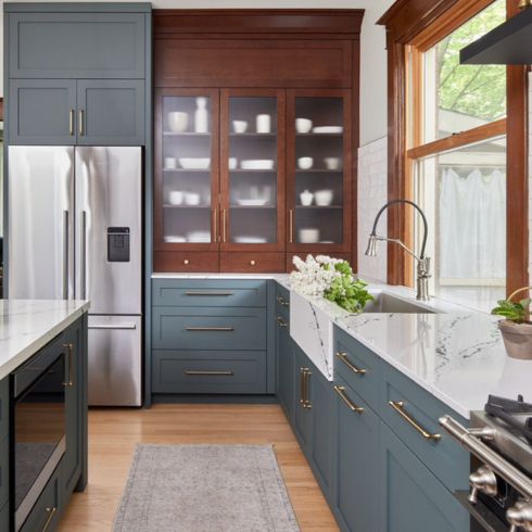 Kitchen with green/blue island and wood pantry