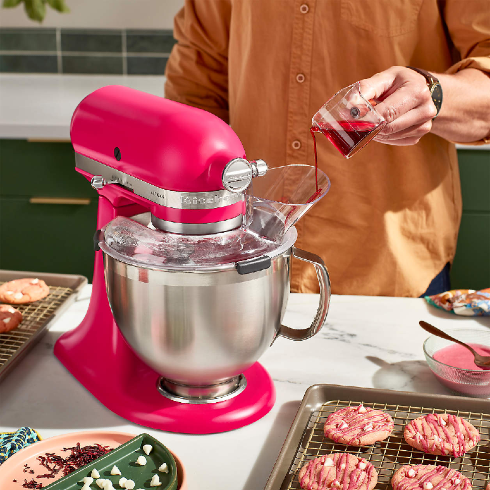 A KitchenAid stand mixer in a hot pink shade