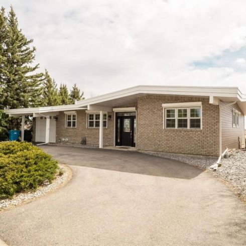 Detached luxury grey brick home in Lethbridge, Alberta