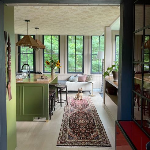 Green kitchen in the country with wallpapered ceiling