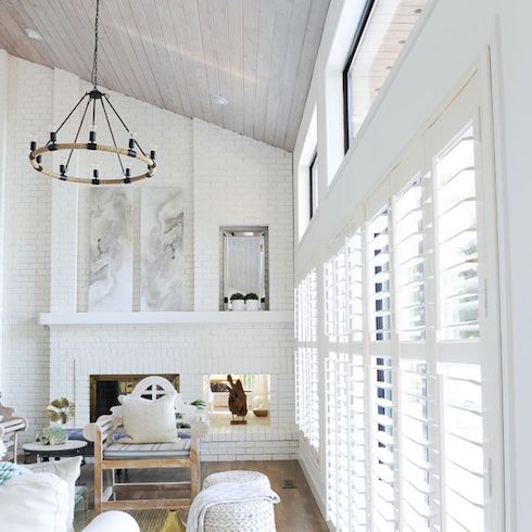 Vancouver Island home renovated by designer Tracey Ayton as featured on Home Network featuring white painted brick walls and shiplap ceiling, white shutters and a black metal ceiling pendant light.