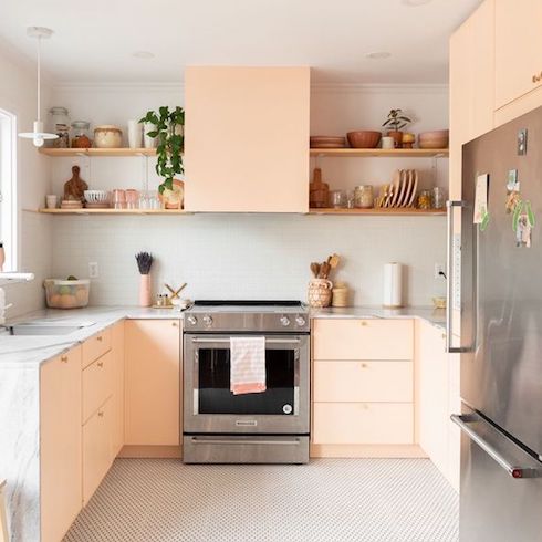 A fully renovated kitchen in a Montreal bungalow with pink cabinets and quartz countertop designed by Lauren Kolyn and featured on Home Network