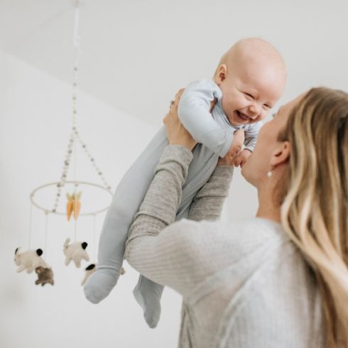 Mom holding baby in the nursery