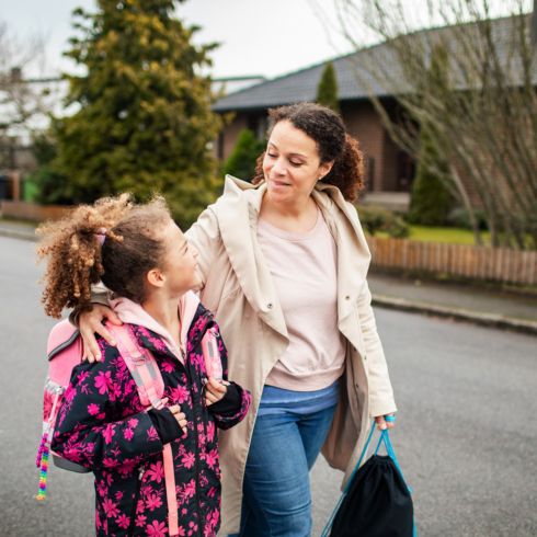 Mom walking kid to school