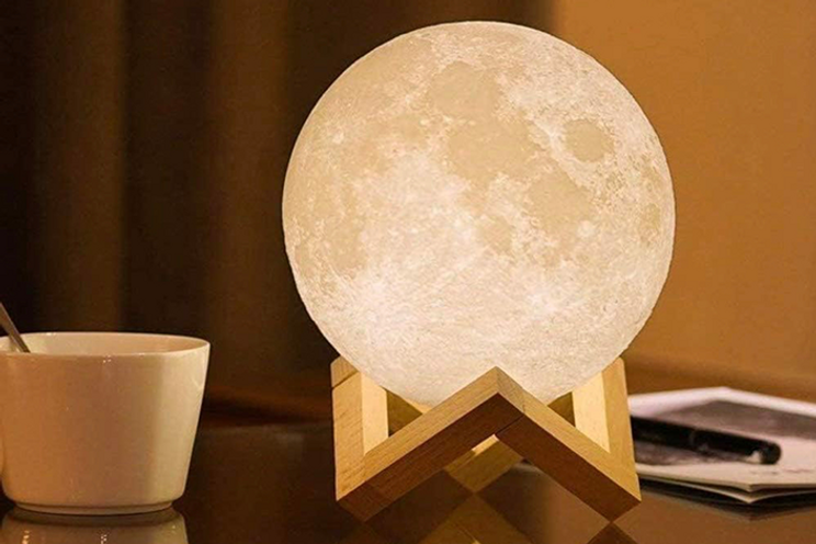 Dream LED moon-shaped lamp on sitting on desk