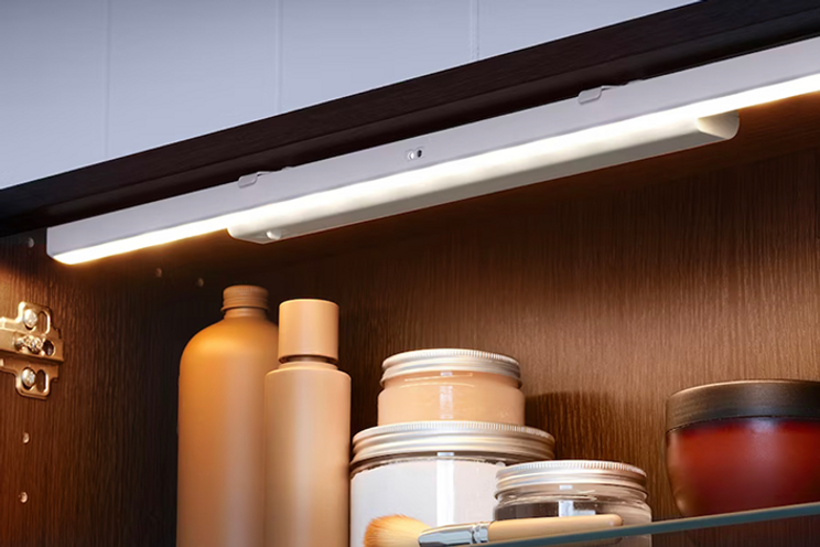Motion-sensor strip IKEA lighting above kitchen shelving