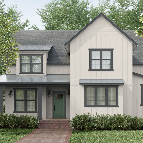 A modern house exterior painted a cream colour with a sage green door