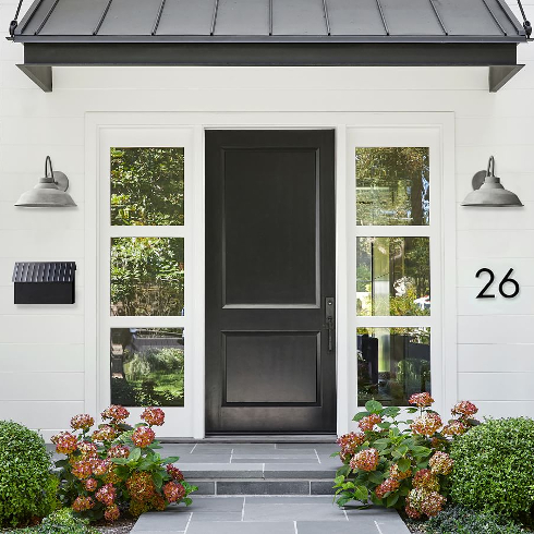 A modern white front walk with a black statement mailbox