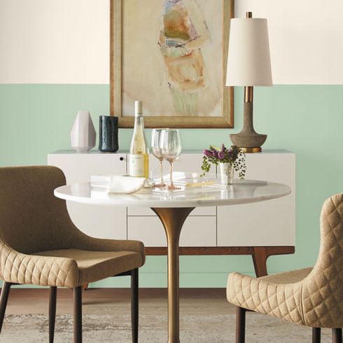 Modern dining room with two-tone wall in white and soft green