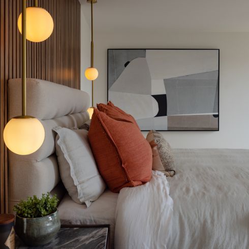 Bedroom with slatted walnut headboard