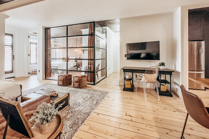 Living space with light wood floors and a work space at <yoastmark class=