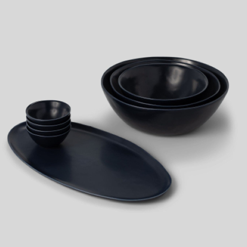 A dark ceramic serving set