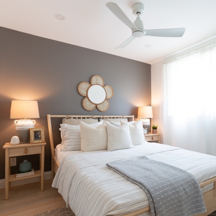 Bedroom with grey painted wall and daisy mirror