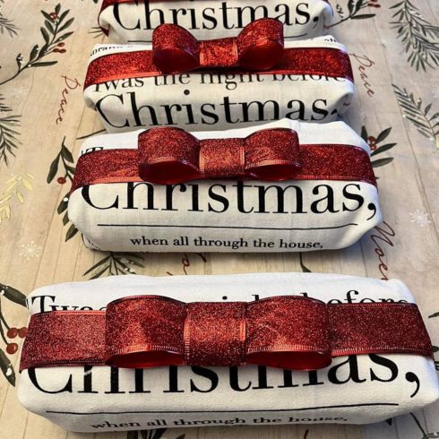 Baked goods wrapped in a Christmas-themed tea towel and a bow